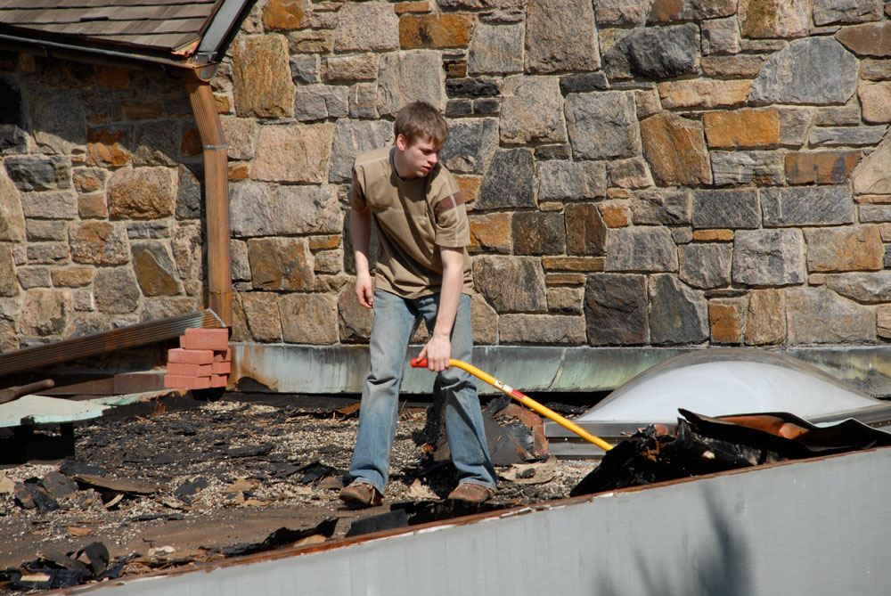 Andre as a teenager helping on a roof