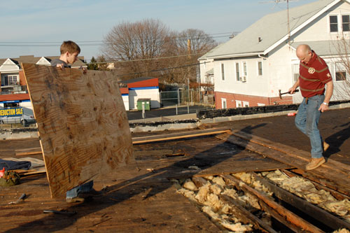 Erik helps repair a flat roof.