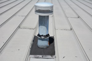 Rubber flashing on a vent pipe on a metal roof