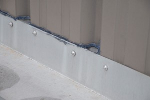 Metal-roof-flashing against wall