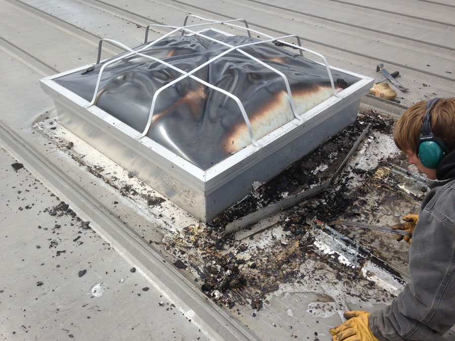 we removed the old tar and cleaned the flashing around the skylight. It is important that old caulking and sealants be removed before our rubber membrane can be applied.