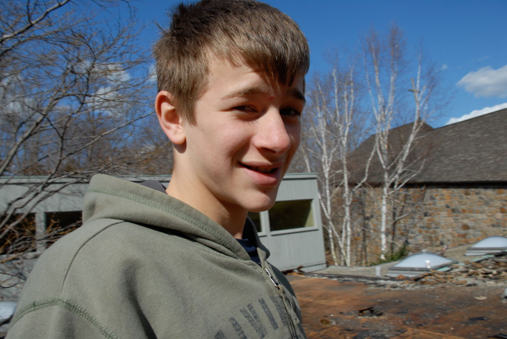 Sven, at the age of 14 taking pictures and videos on roofs we worked on.