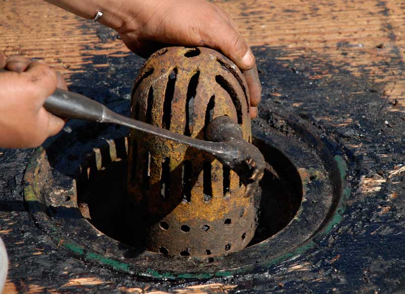 Metal strainer with small holes and slots