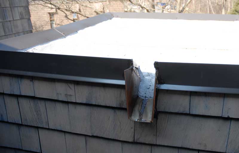 Scupper - an opening on the edge of roof allowing water to drain off