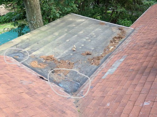 Patches on a EPDM rubber flat roof. these rubber roofs don't last. These roofs get punctured easily.