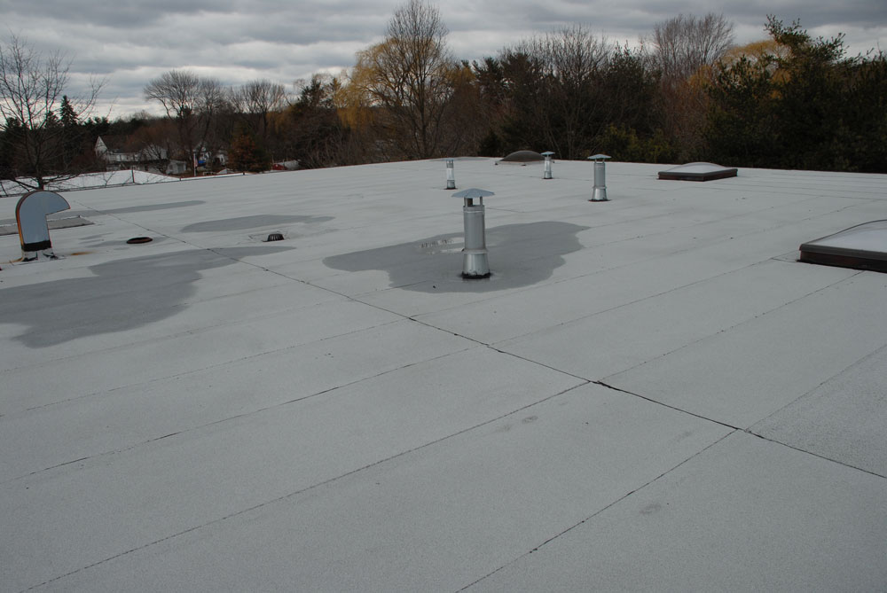 Modified Bitumen Membrane roof Westport CT. This 2 ply rubber roof is 20 years old and there are no patches.