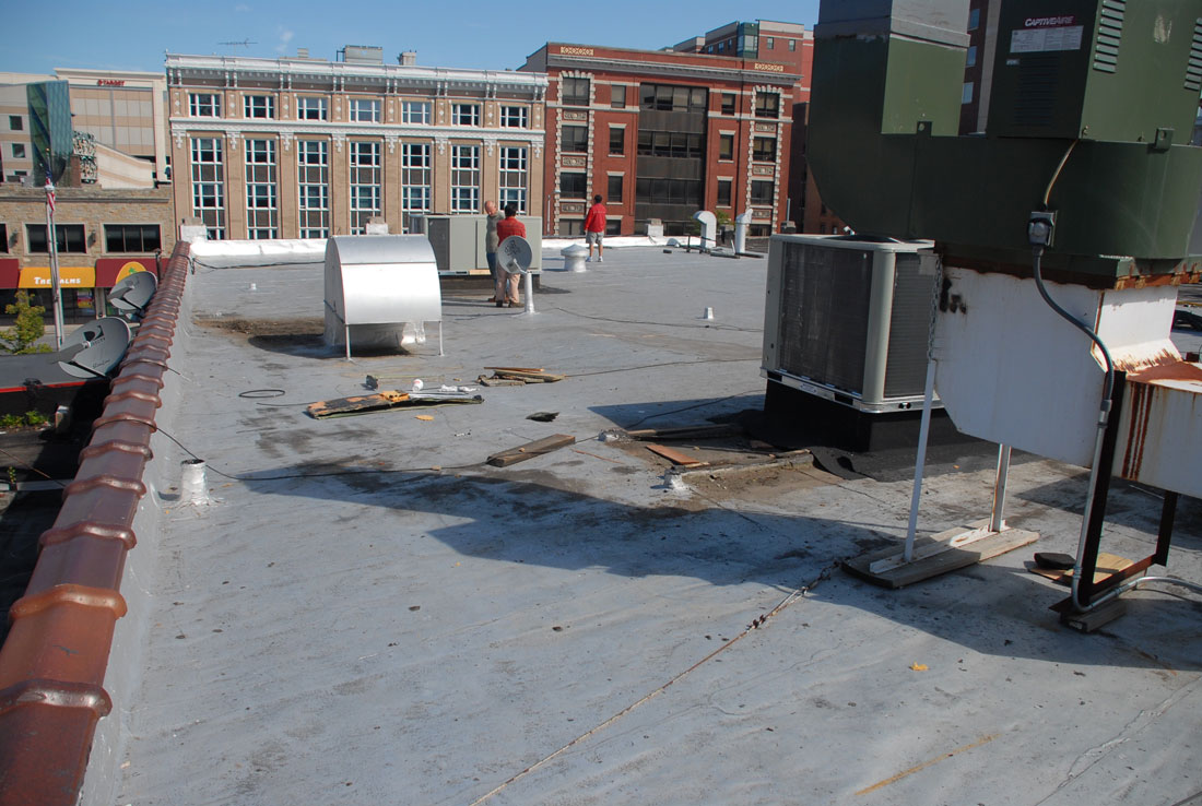 Debris on a commercial roof Stamford. this flat roof shows how much abuse it can take. All the debris and work that was done on top of it.