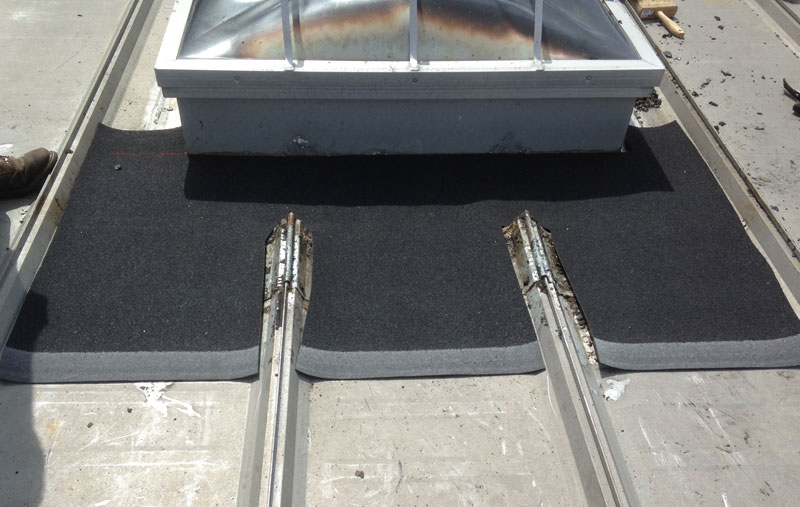 Rubber membrane serves as flashing around skylight Installing a rubber membrane around a skylight on a metal roof
