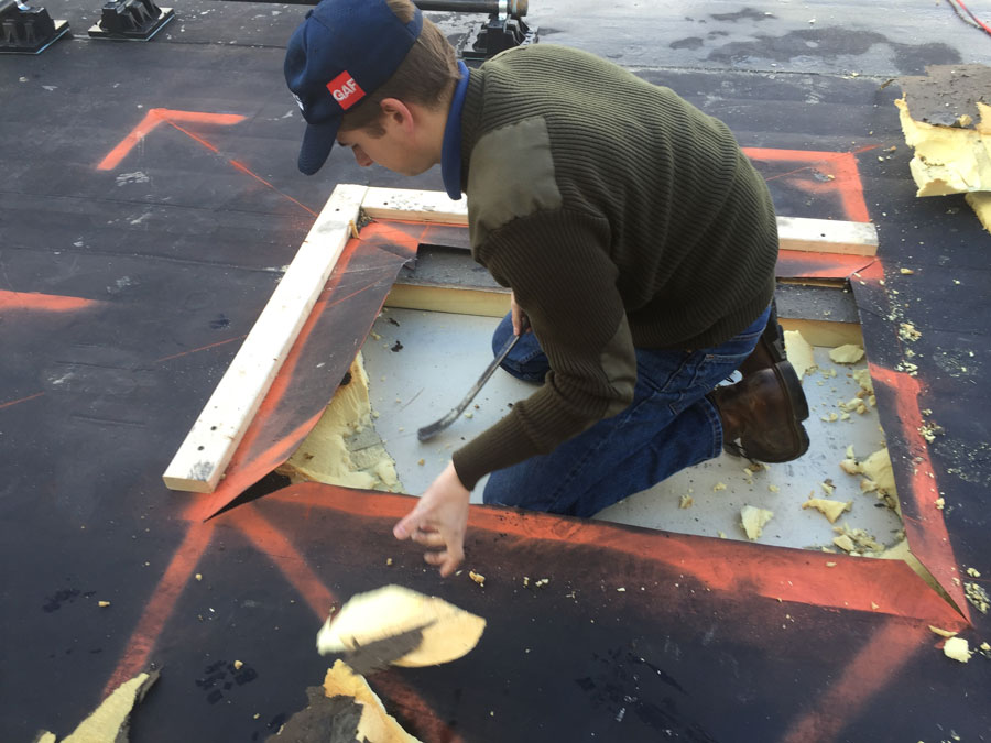 Preparing the roof to cut a hole through the metal