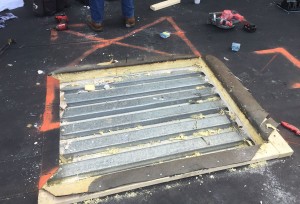 Metal roof exposed under the rubber membrane and insulation