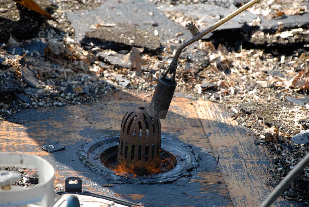 Repairing a Roof Drain - cleaning of and removing roofing material Repairing a Roof Drain - cleaning of and removing roofing material