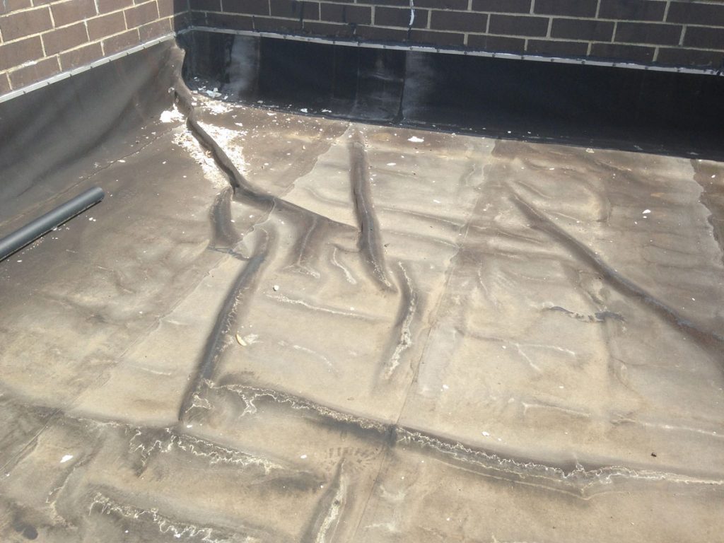 Installing over an existing Modified Bitumen Rubber Membrane - Cut away the wrinkles Installing over an existing Modified Bitumen Rubber Membrane - Cut away the wrinkles